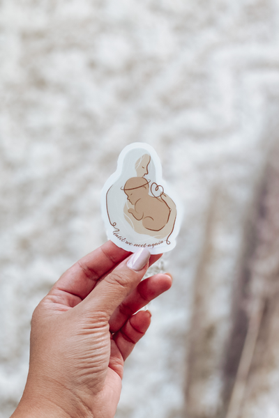 Mom holding angel baby in her arms with text Until we meet again die cut sticker with clear backing.